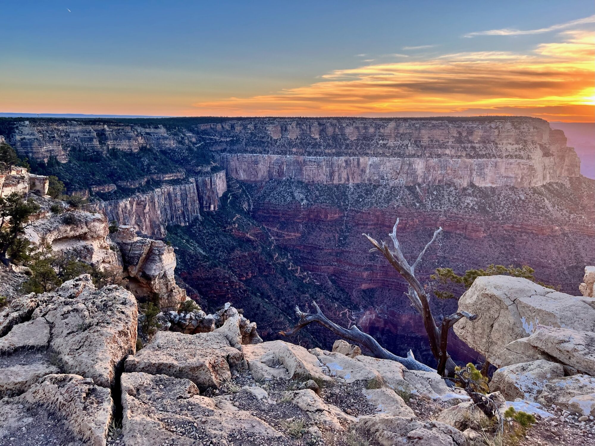 The Grand Canyon at sunset, with the Bright Angel Trail winding below the rim