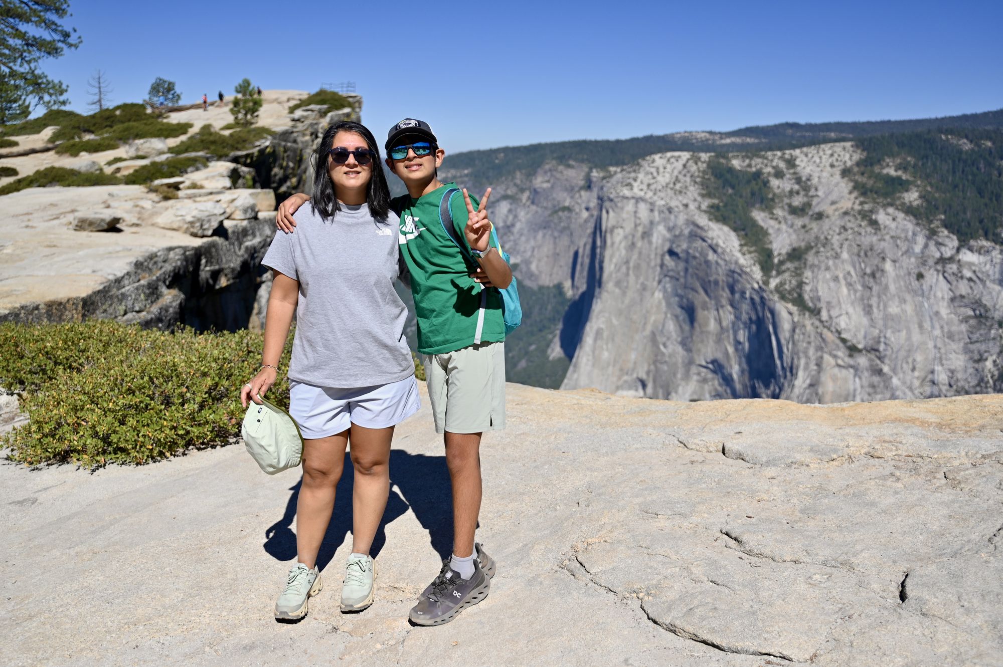 Our son and I standing on flat granite at Taft Point, with El Capitan across the valley behind us.