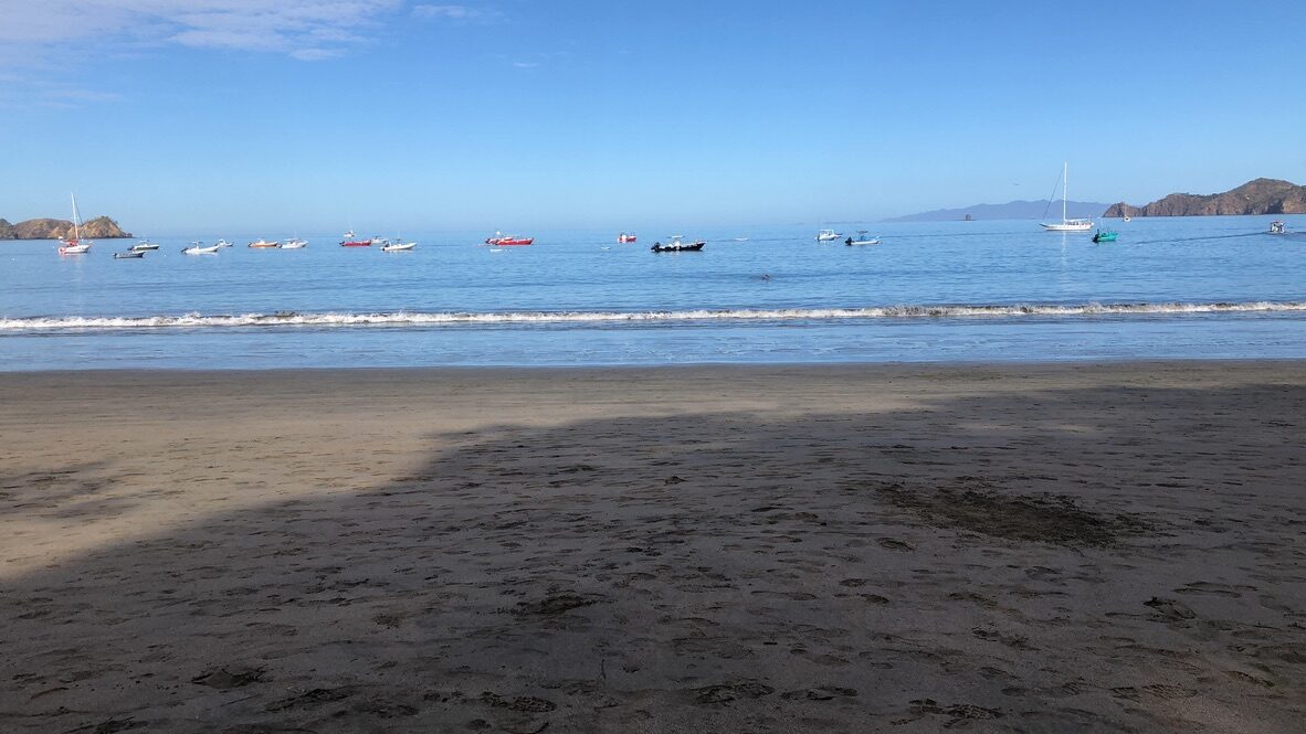 Boats anchored in the calm bay off Playa Hermosa