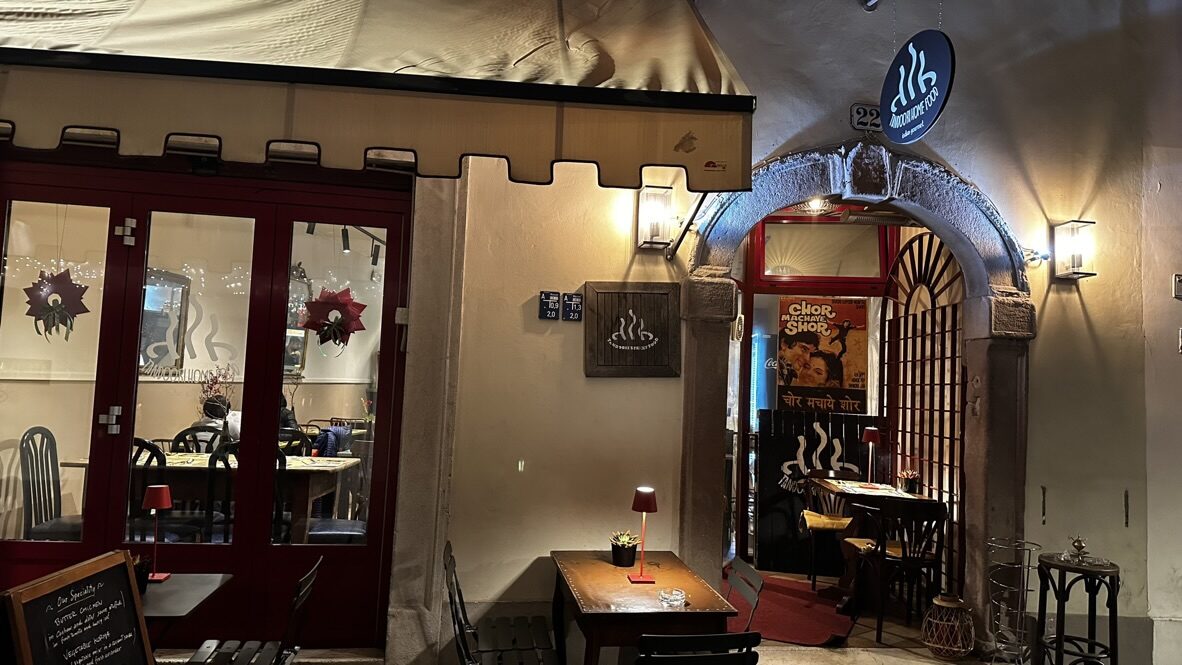 The warmly lit entrance of an Indian restaurant in Bolzano