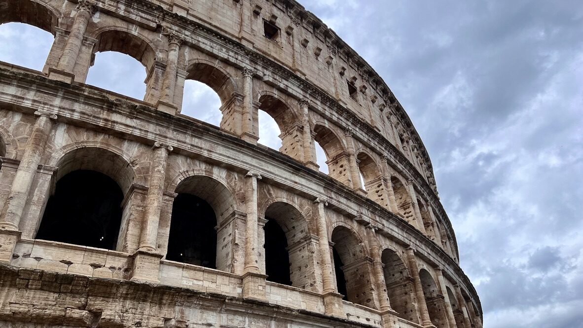 The Colosseum’s outer arches against a cloudy sky