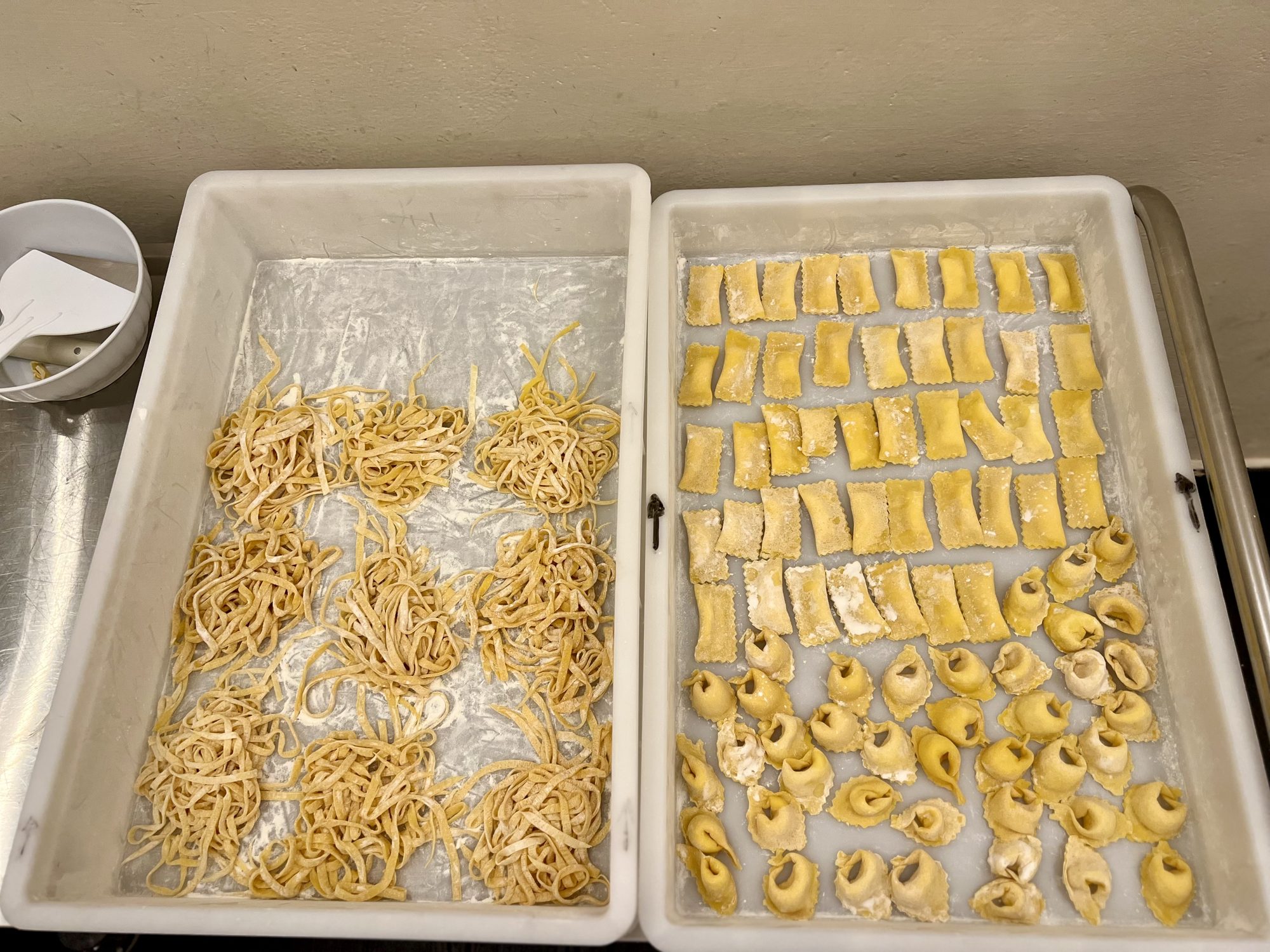 Two trays of fresh handmade pasta and ravioli