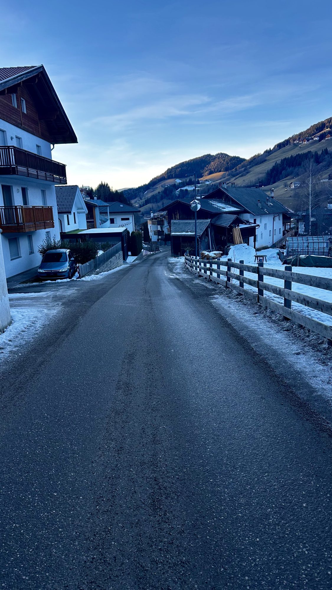 A quiet road through the village of Santa Maddalena at dusk