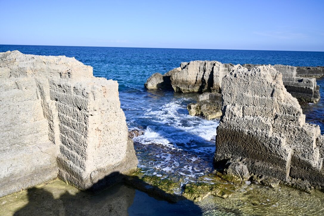 Rocky limestone blocks with the sea washing between them