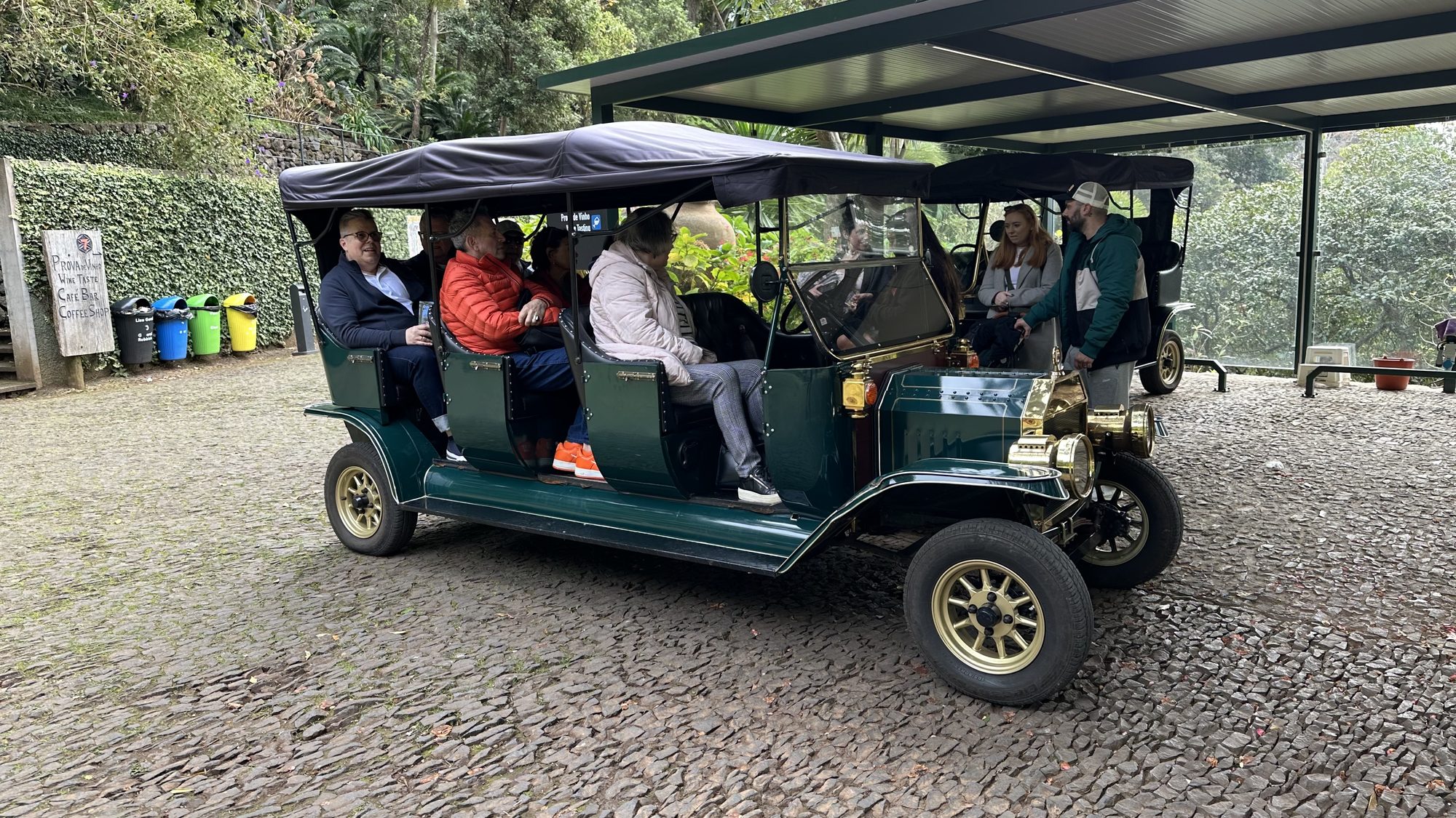 My parents seated in an open, vintage-style cart under a shelter, ready for the ride back up.