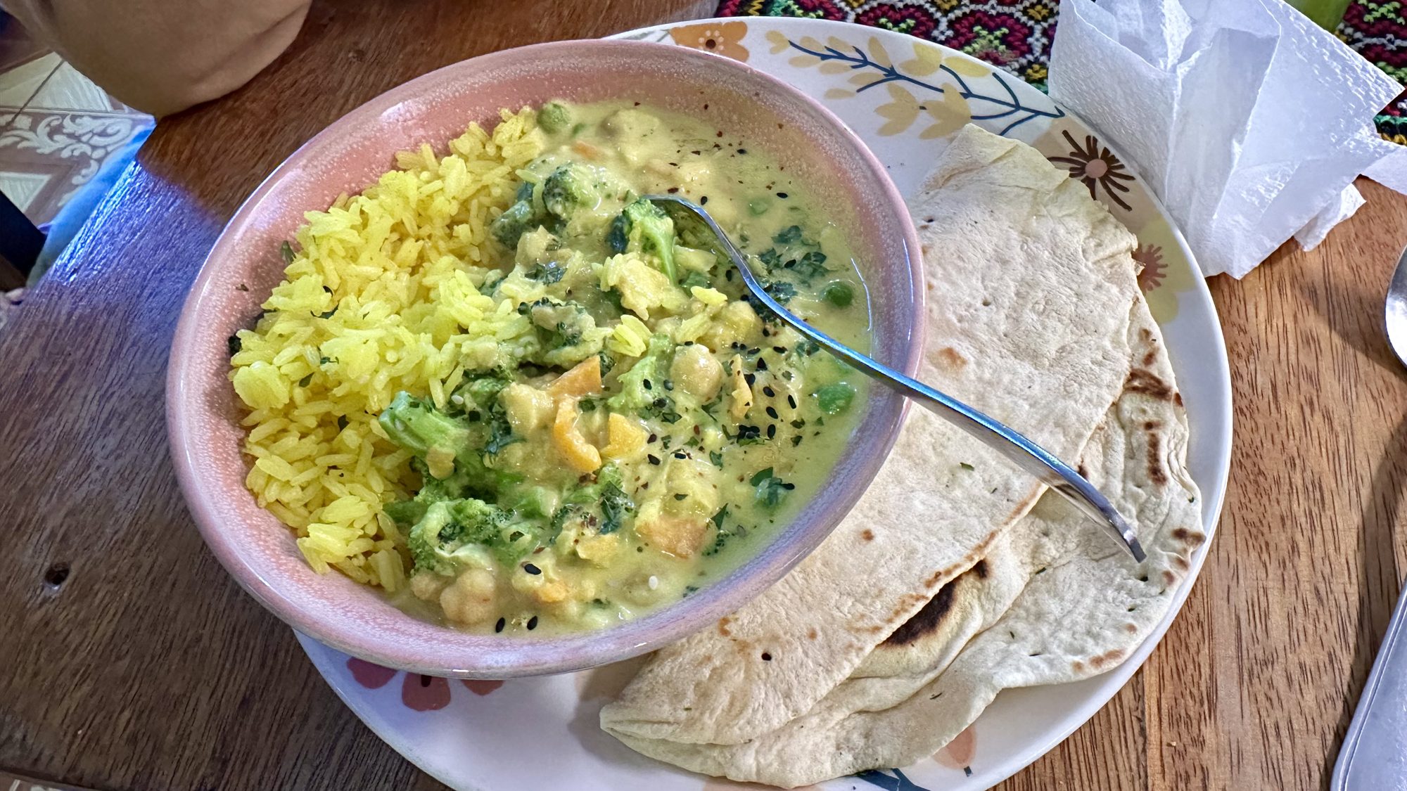 A bowl of turmeric coconut curry with flatbread