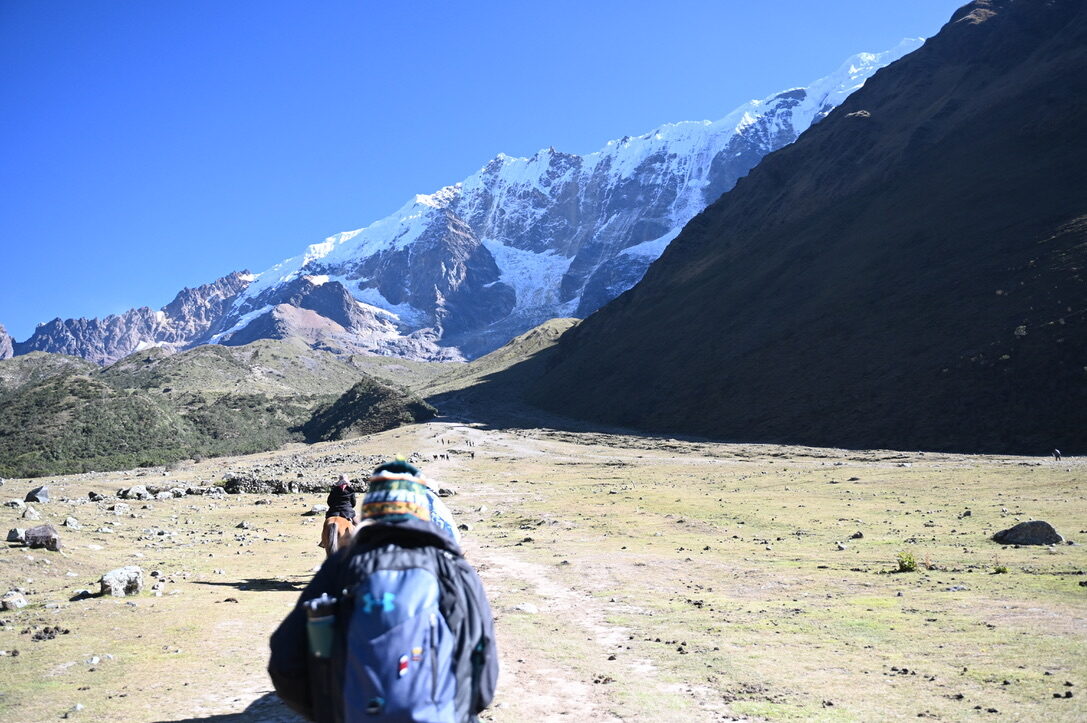 Riders on horseback heading up toward the glacier-covered mountain