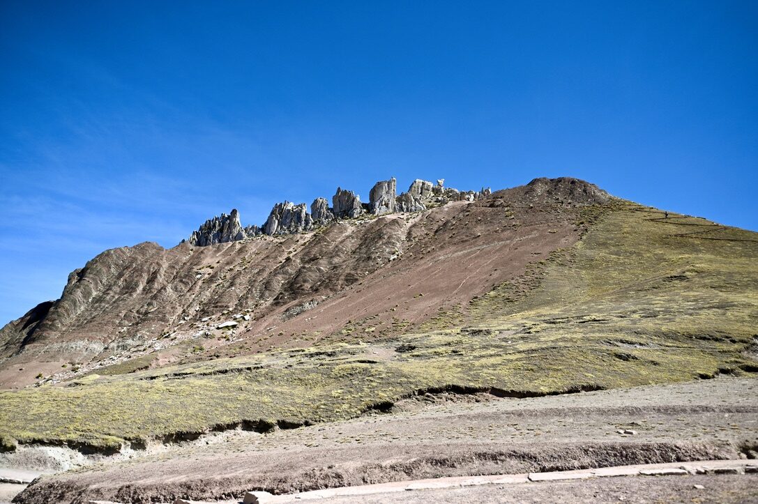 Jagged rock spires along a ridge above the trail