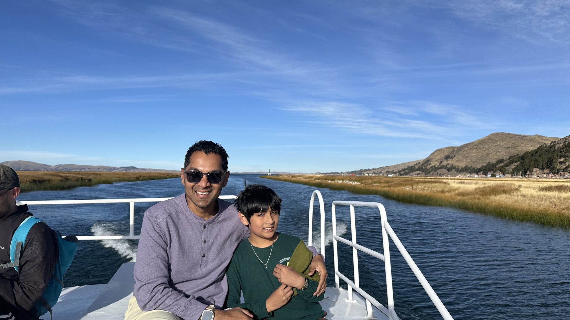 Man and boy smiling on the top deck of the boat