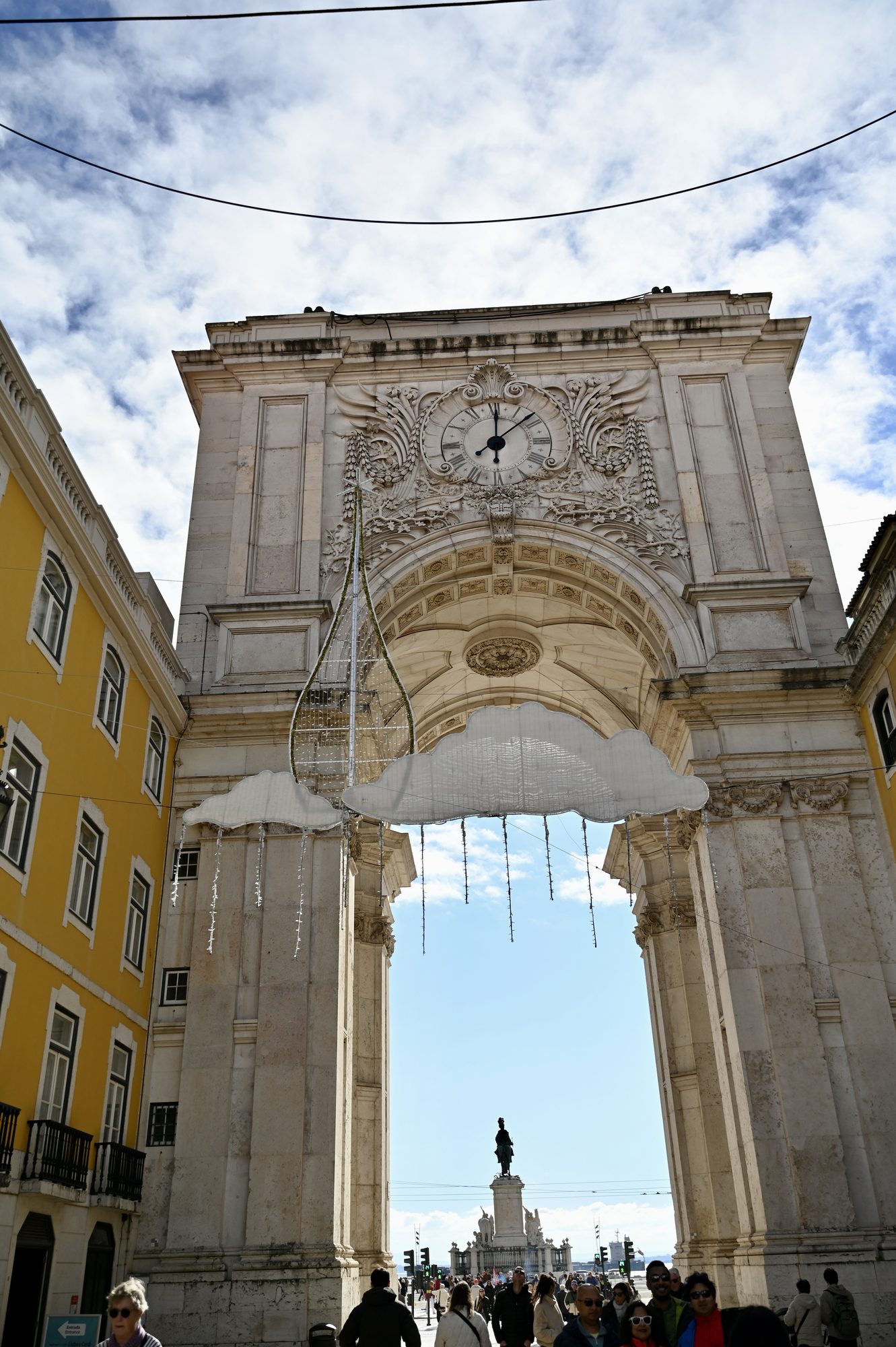 The triumphal Rua Augusta Arch, with its clock and Christmas decorations hanging beneath, opening onto the Praça do Comércio.